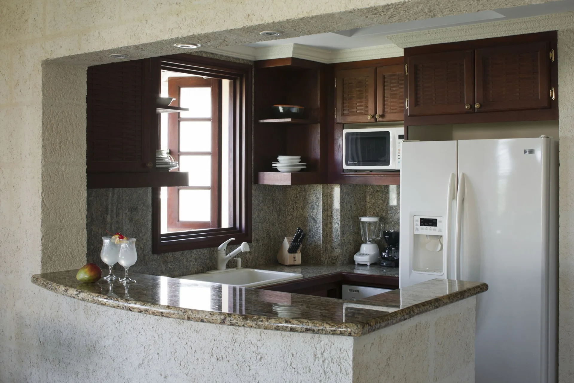 Two-bedroom ocean view suite kitchen with granite counter and appliances at The Crane Resort.