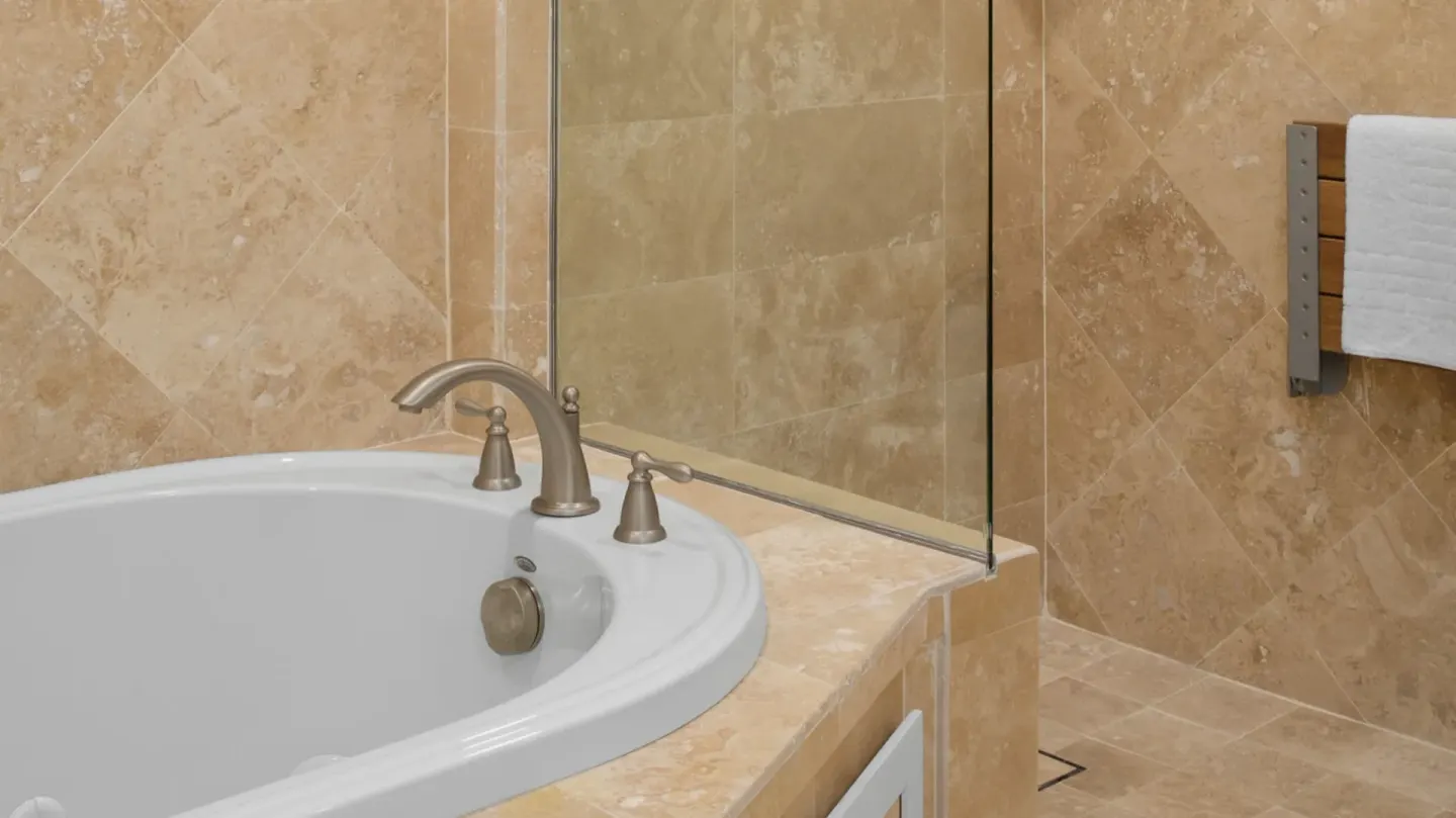 Suite bathroom with soaking tub and glass shower at The Crane Resort