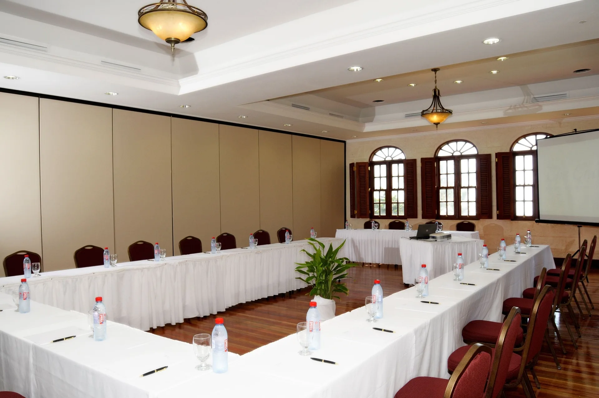 Conference tables arranged in a U shape in a meeting room at The Crane Resort.