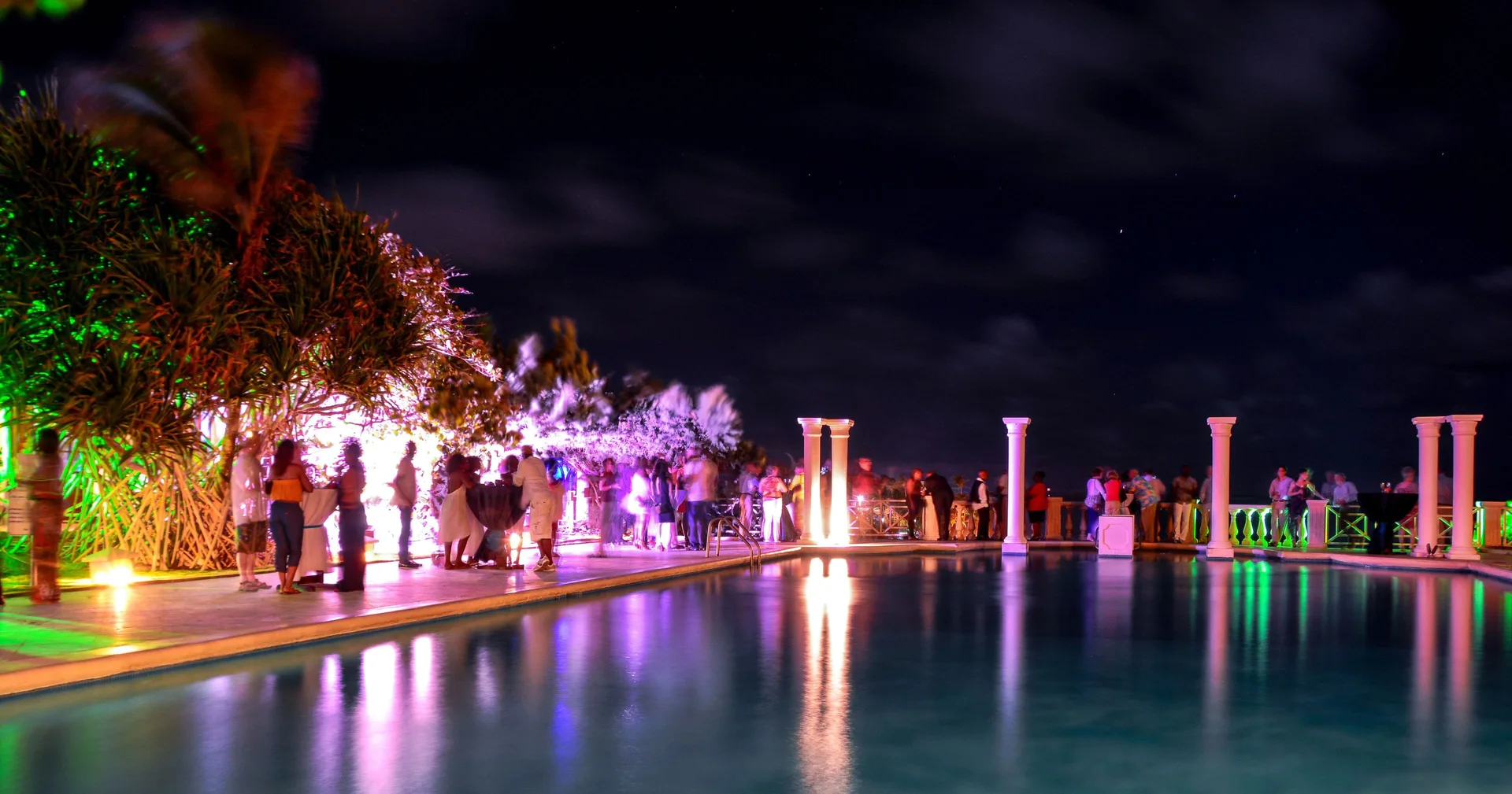 Nighttime poolside event with colorful lights at The Crane Resort.