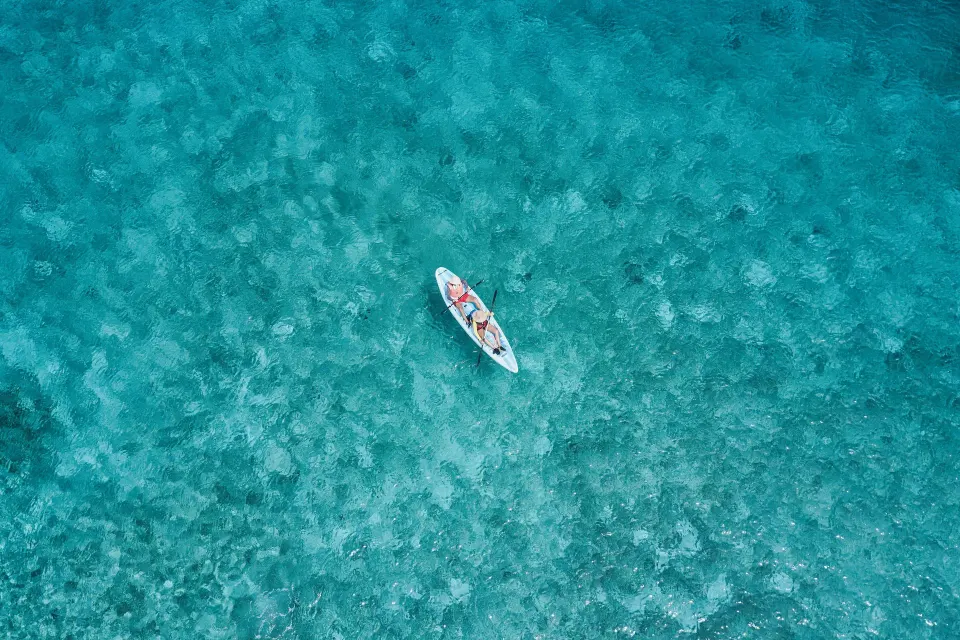 Aerial view of a kayak on clear turquoise water at The Explorean Cozumel.