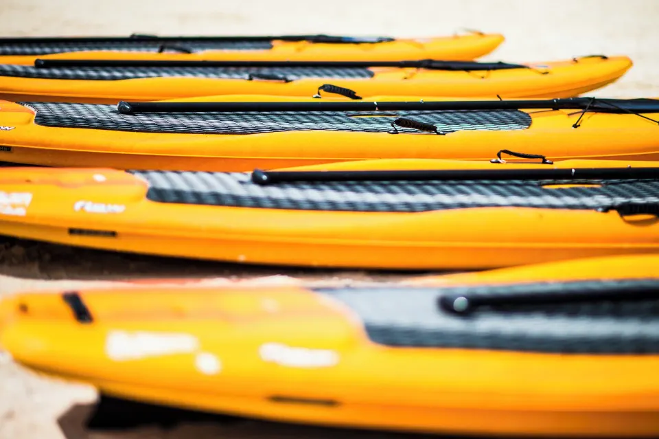 Stack of yellow kayaks on the sand at The Explorean Cozumel