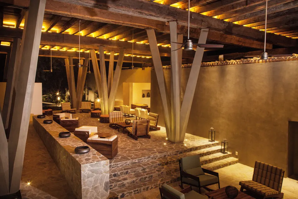 Evening view of the covered lounge area with warm lighting at The Explorean Cozumel