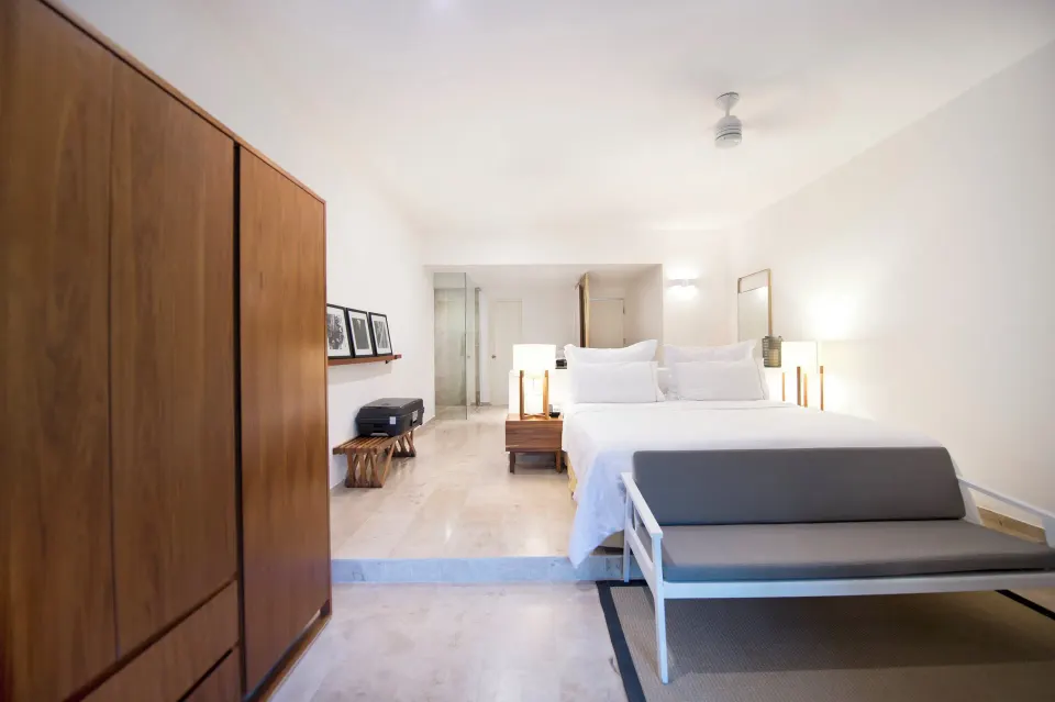 King bed viewed from the wardrobe side showing en suite area at The Explorean Cozumel