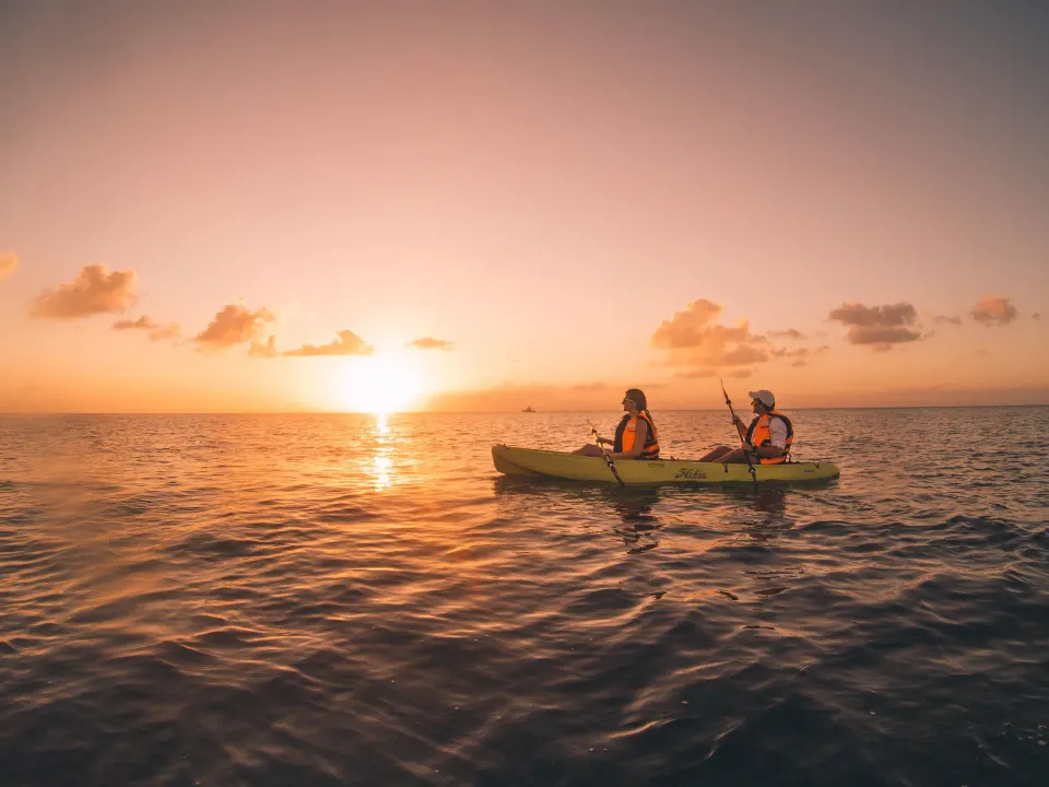 Two guests kayaking at sunset on the ocean near The Explorean Cozumel