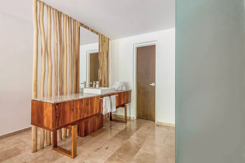 Wooden double sink vanity with natural timber divider at The Explorean Cozumel