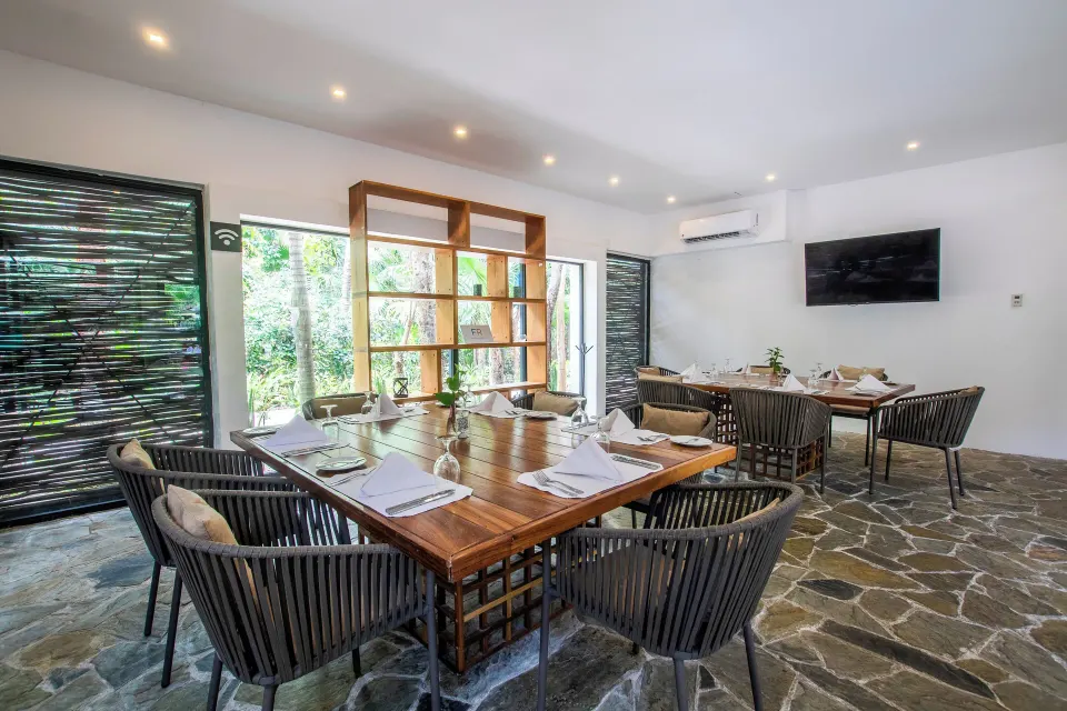 Private dining or meeting room with modern chairs and set table at The Explorean Cozumel