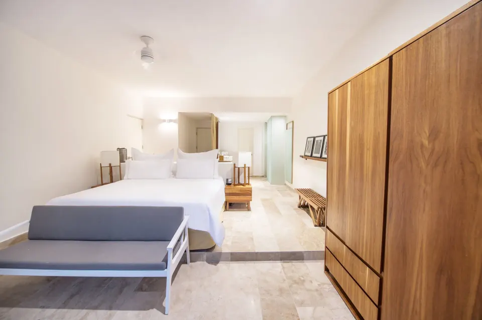 Wide-angle view of king bed and wardrobe in a Casita Stand Alone room at The Explorean Cozumel