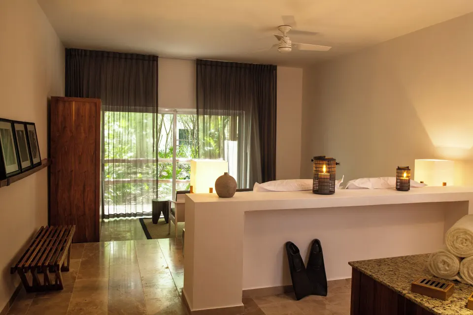 Open-plan Casita room interior with partition and balcony at The Explorean Cozumel