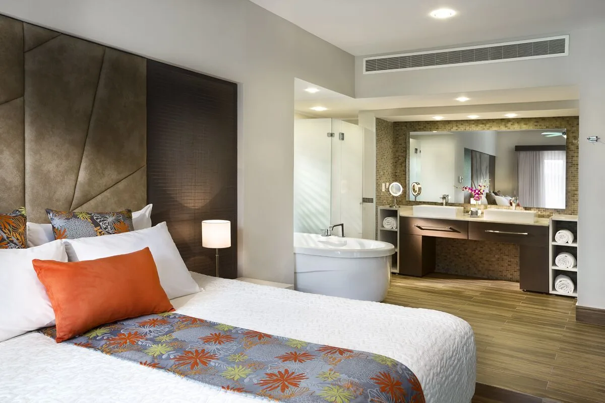 King-bed suite with open bathroom and soaking tub at The Fives Beach Hotel.