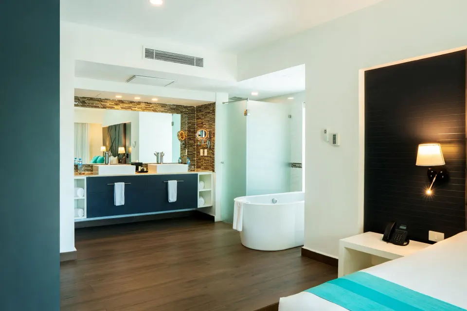 One Bedroom Penthouse Suite bath and king bed area at The Fives Beach Hotel.