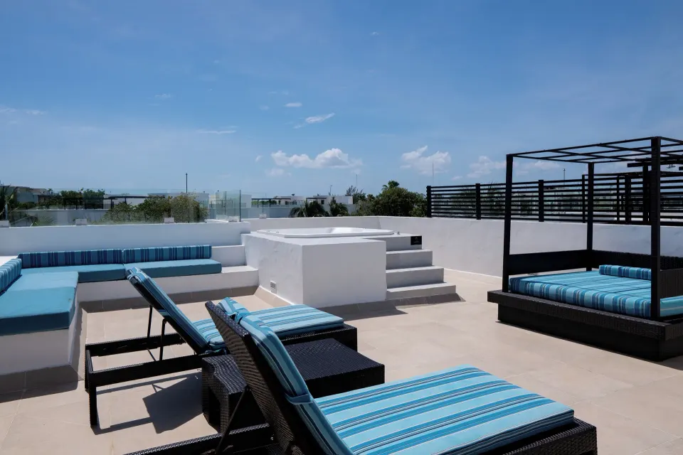 One Bedroom Penthouse Suite rooftop terrace with loungers at The Fives Beach Hotel.