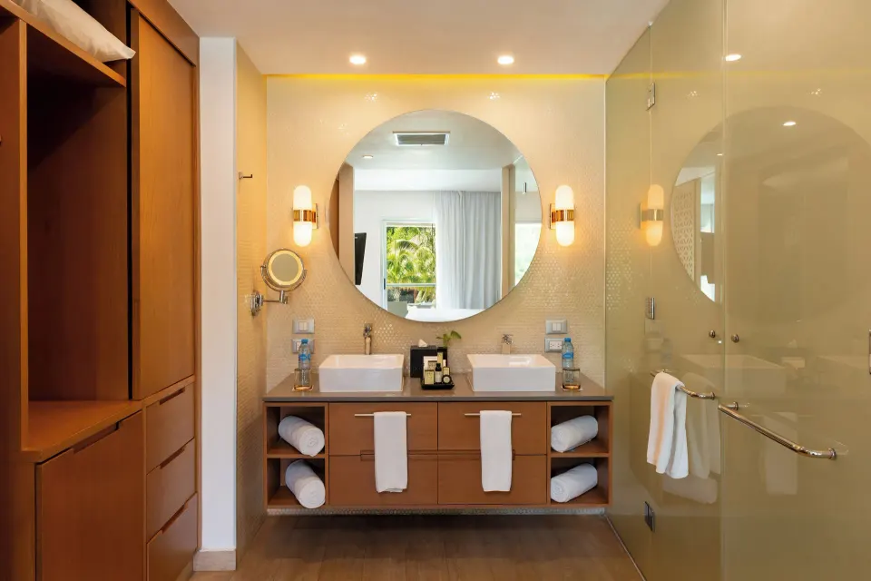 One Bedroom Suite bathroom with double sinks and glass shower at The Fives Beach Hotel.