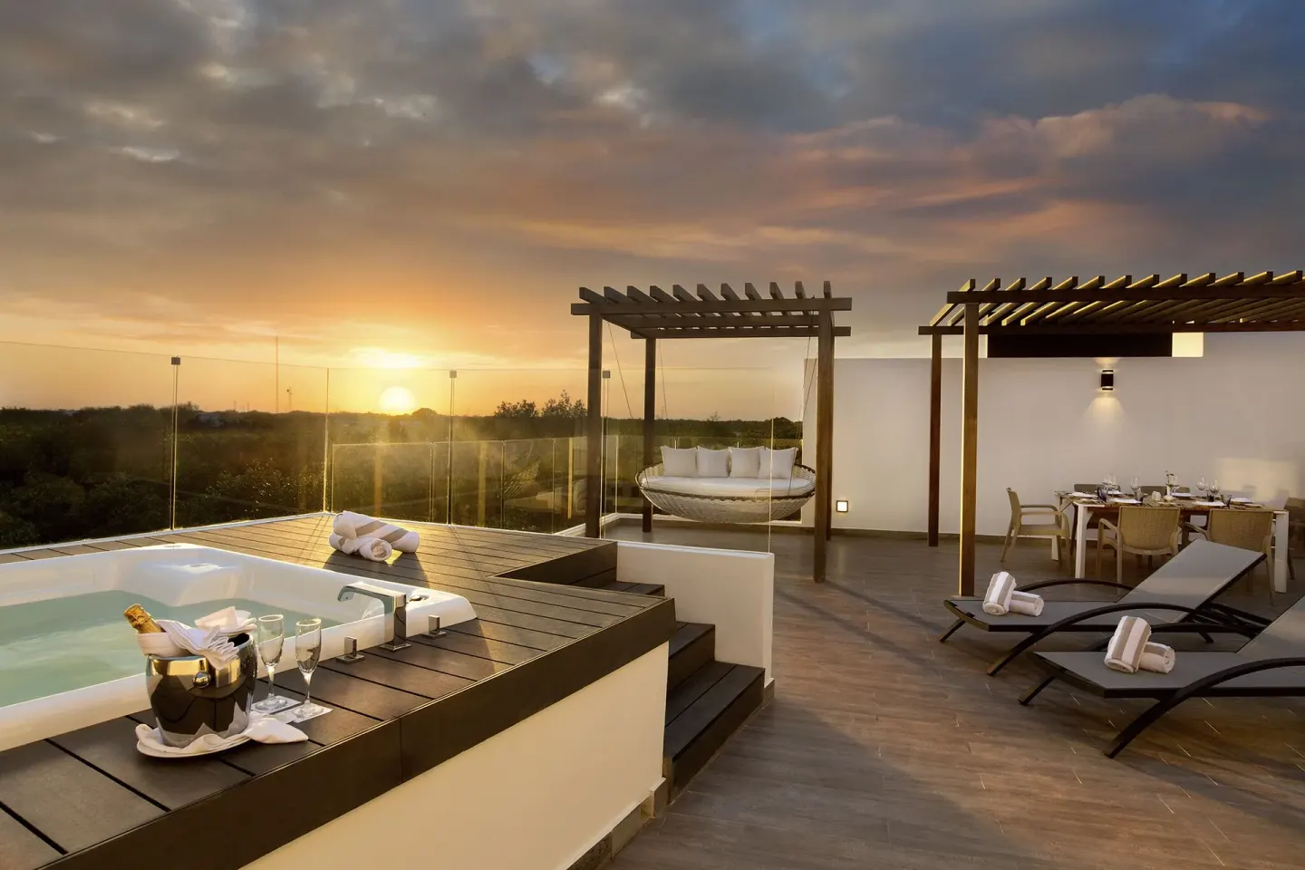 Three Bedroom Penthouse Sky Suite rooftop terrace at The Fives Beach Hotel with hot tub and sunset seating.