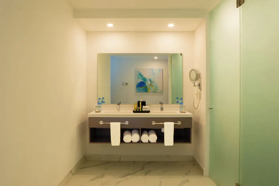 Three Bedroom Suite bathroom vanity with towels at The Fives Beach Hotel.
