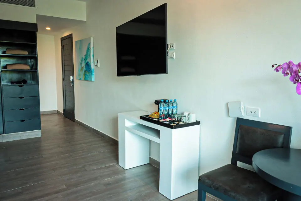 Three Bedroom Suite entry area with TV, storage and table at The Fives Beach Hotel.