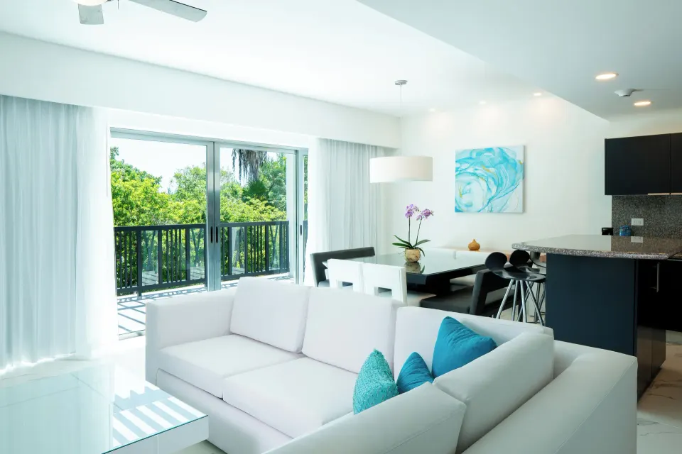 Three Bedroom Suite lounge, dining area, and balcony at The Fives Beach Hotel.