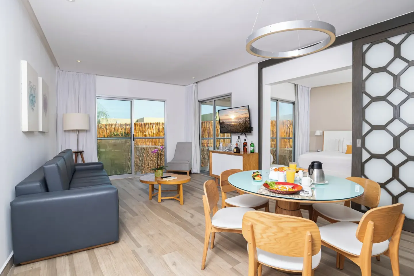 Two Bedroom Suite living and dining area with bedroom visible at The Fives Beach Hotel.