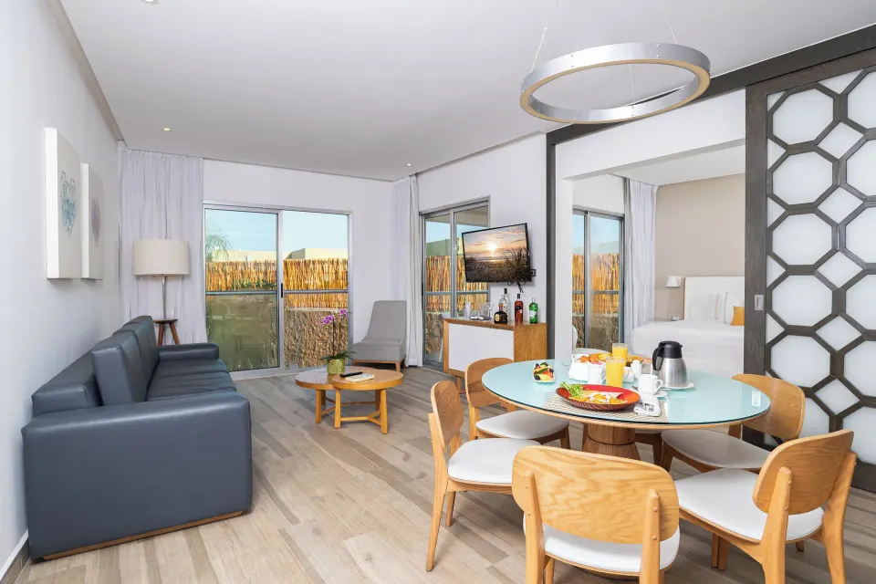 Two Bedroom Suite living and dining room with bedroom visible at The Fives Beach Hotel.
