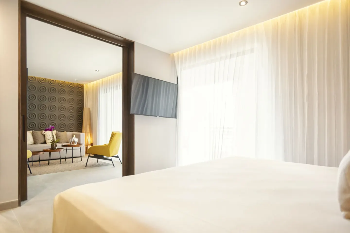 Guest room king bed and sitting room at The Fives Oceanfront Riviera Maya.