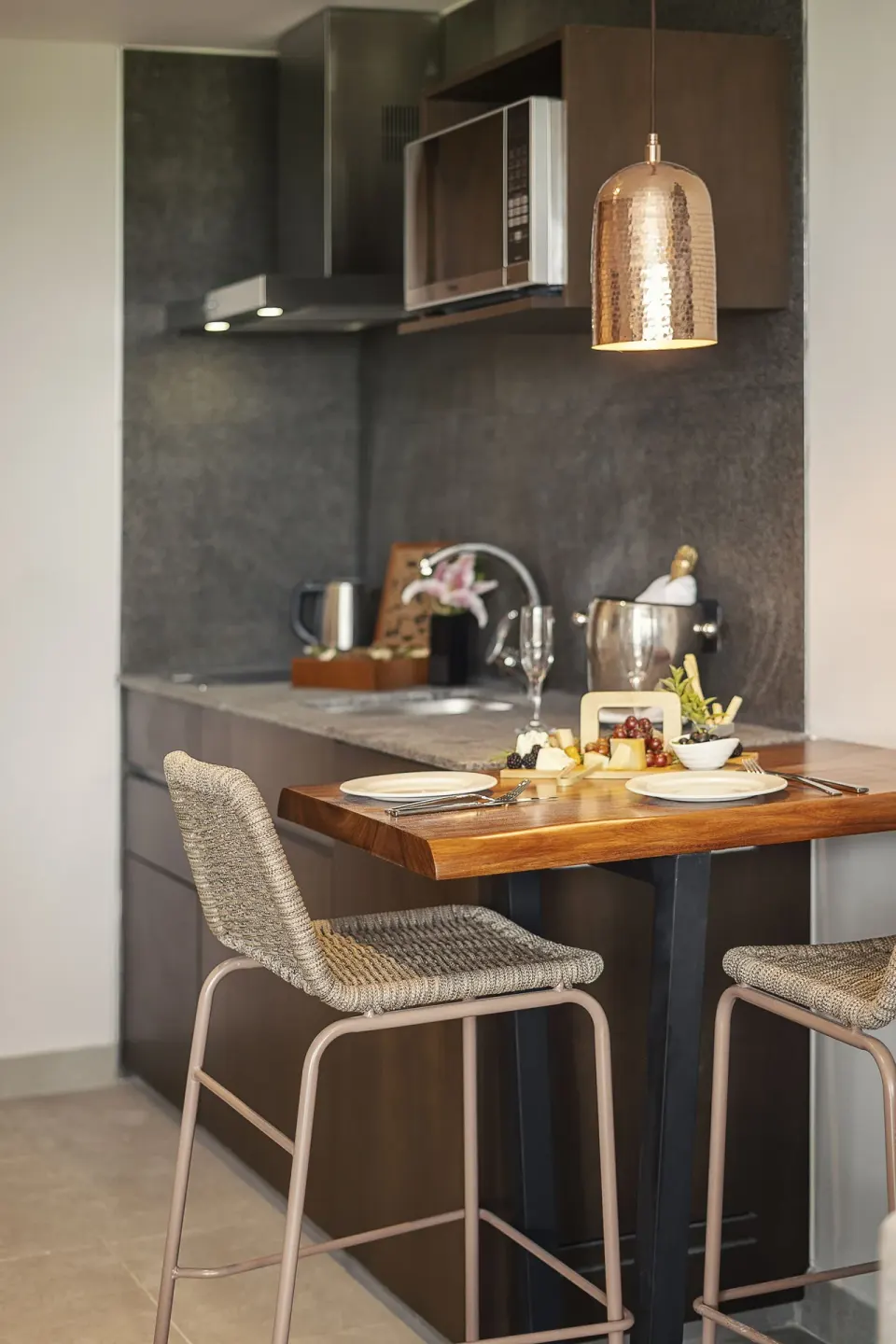 Guest room kitchenette and dining table at The Fives Oceanfront Riviera Maya.