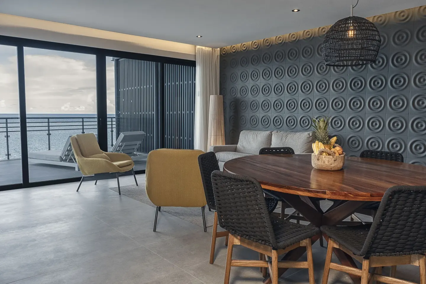 Ocean-view suite dining area and balcony at The Fives Oceanfront Riviera Maya.