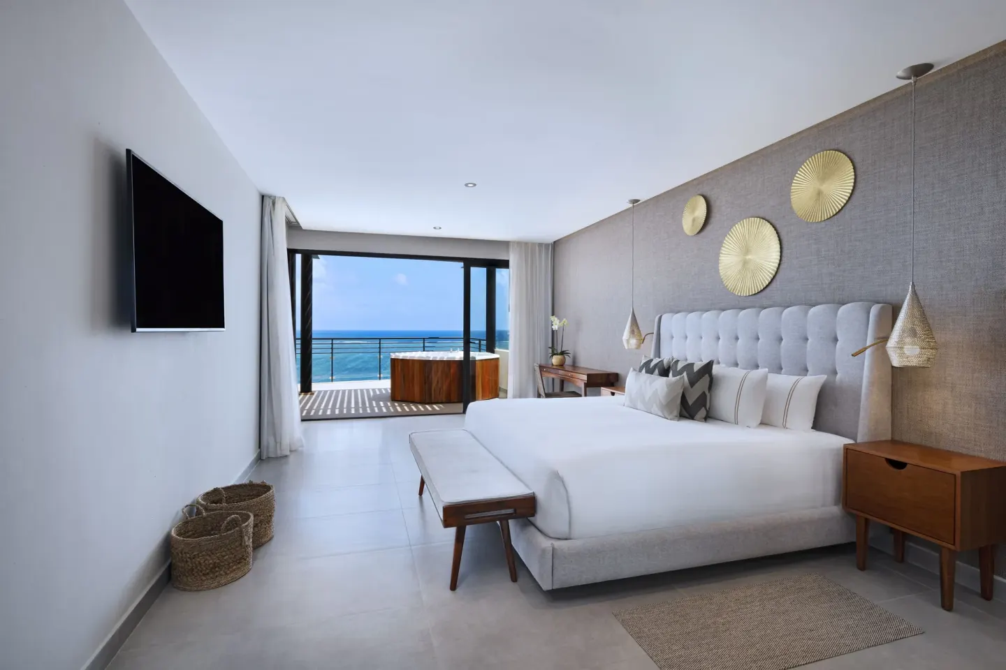King bed guest room with balcony hot tub and ocean view at The Fives Oceanfront Riviera Maya.