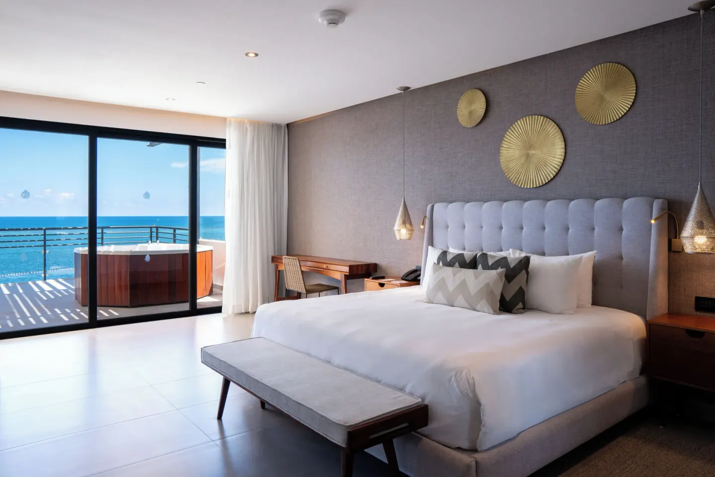 King bed guest room with terrace hot tub and ocean view at The Fives Oceanfront Riviera Maya.
