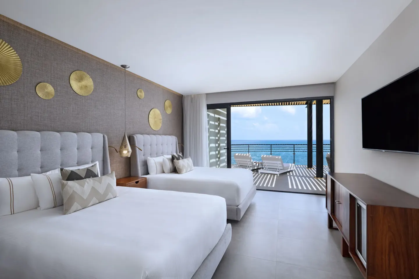 Two-bed oceanfront guest room with balcony at The Fives Oceanfront Riviera Maya.