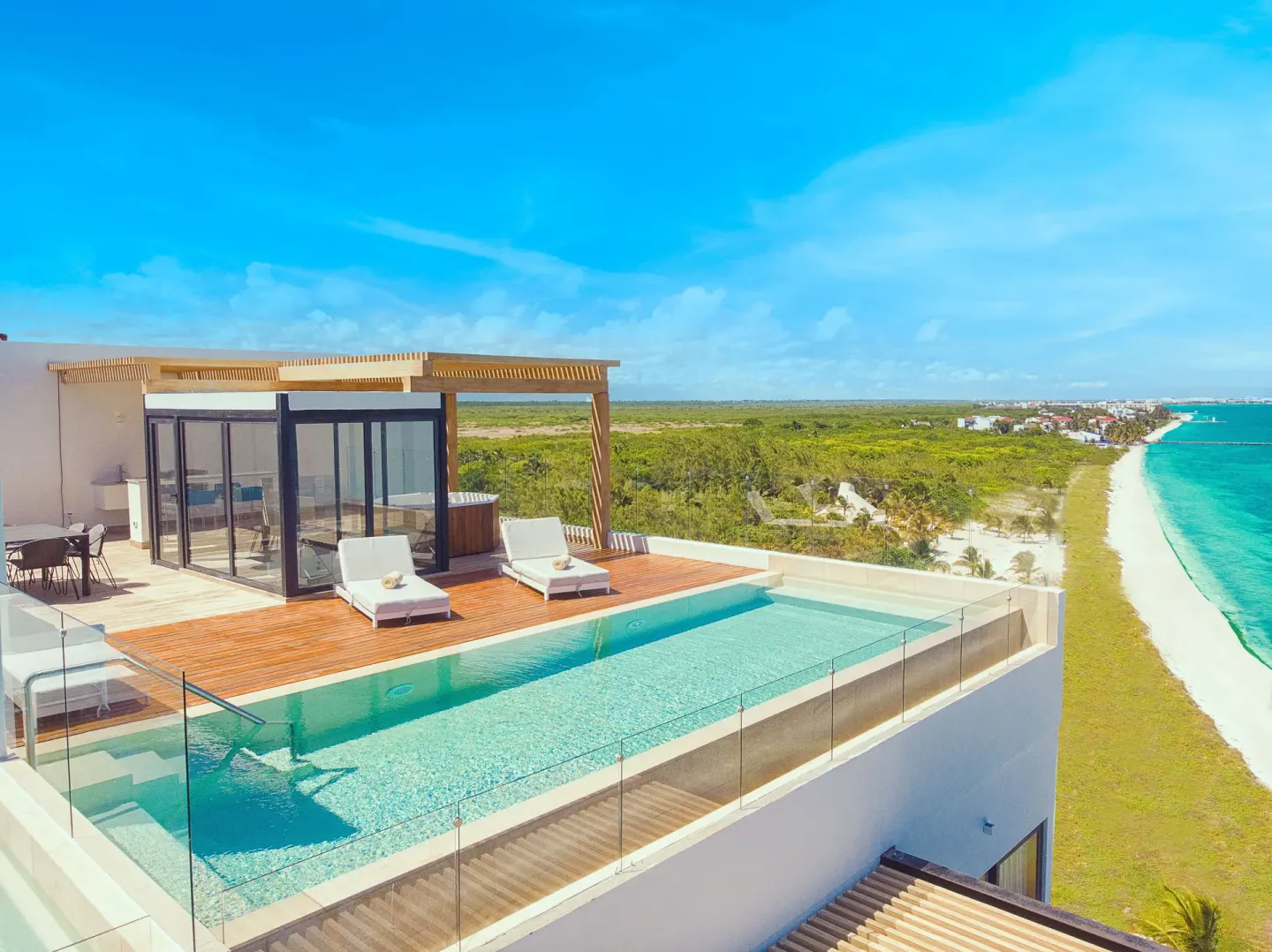 Rooftop pool deck overlooking the beach at The Fives Oceanfront Riviera Maya.