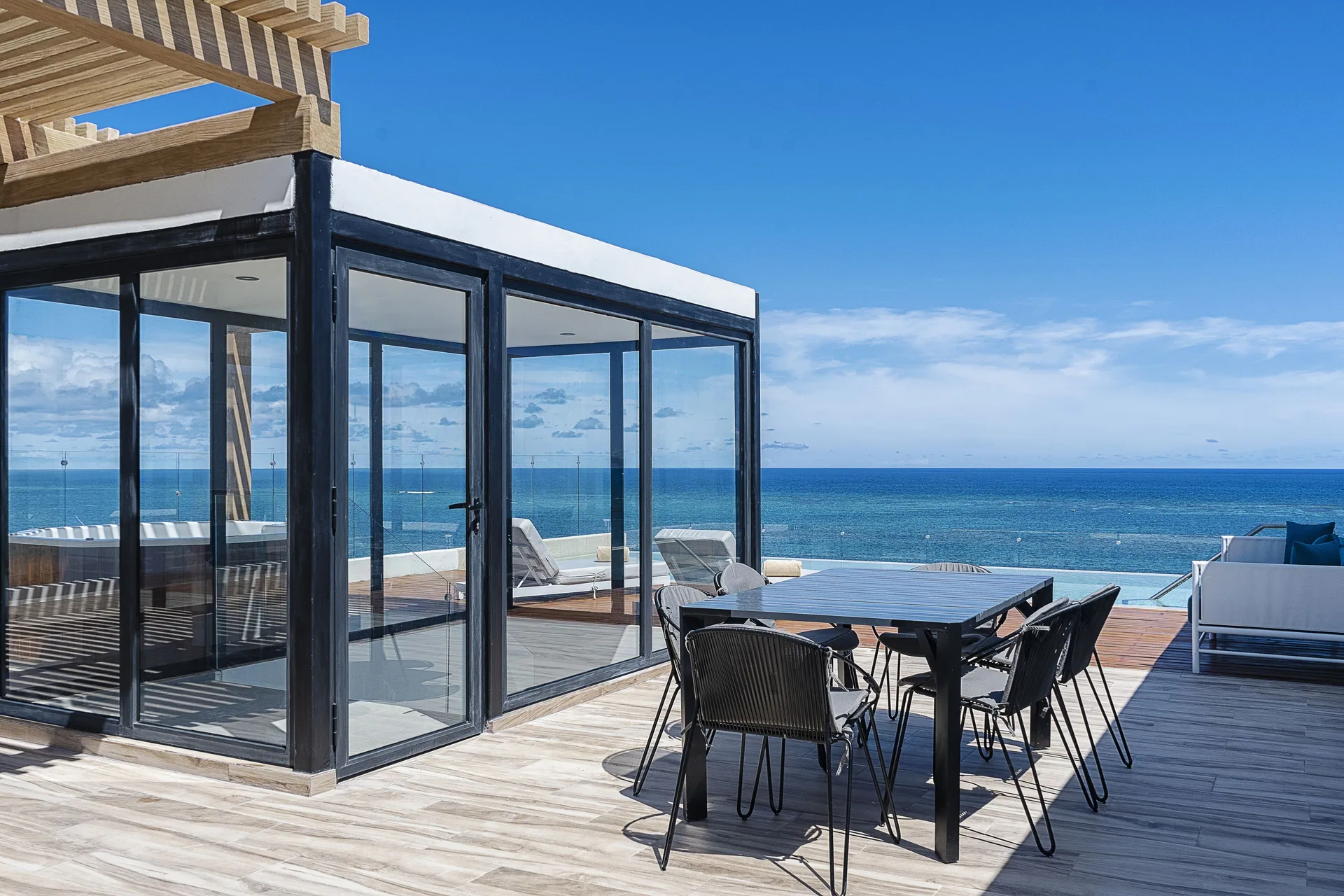 Rooftop terrace seating and ocean view at The Fives Oceanfront Riviera Maya.