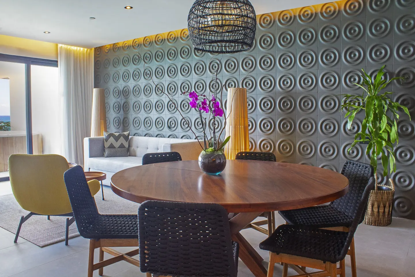 Suite dining table beside lounge seating at The Fives Oceanfront Riviera Maya.