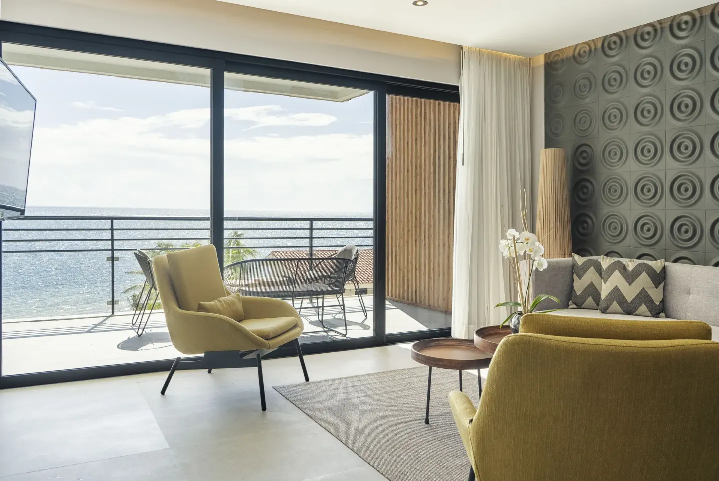 Suite lounge with balcony and ocean view at The Fives Oceanfront Riviera Maya.
