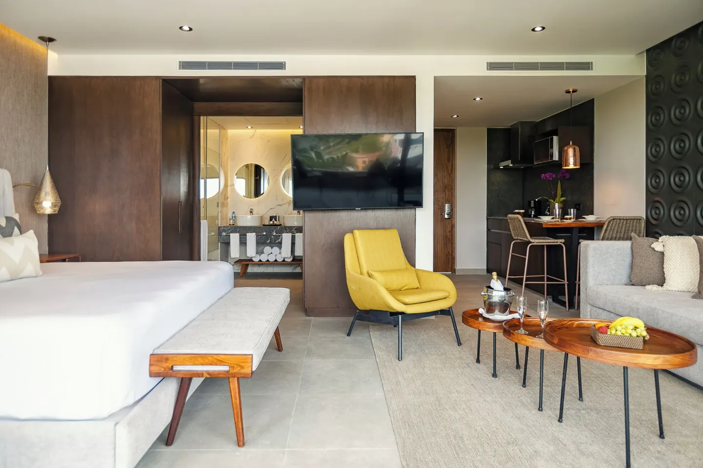 Junior Suite with king bed, sitting area and kitchenette at The Fives Oceanfront Riviera Maya.