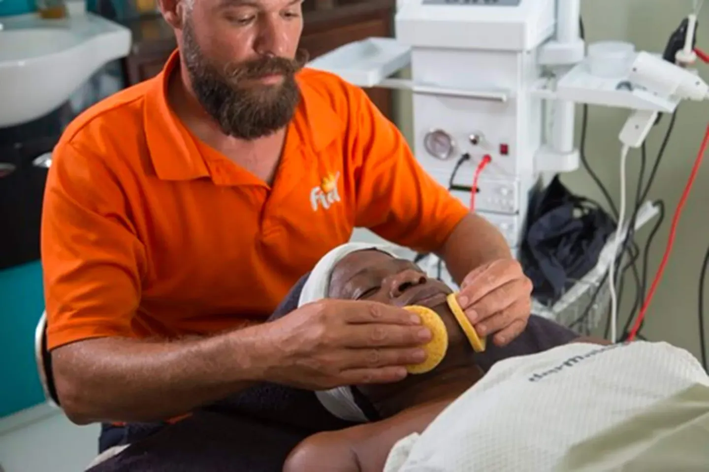 A spa staff member applies facial pads to a guest during a treatment at The Fred.