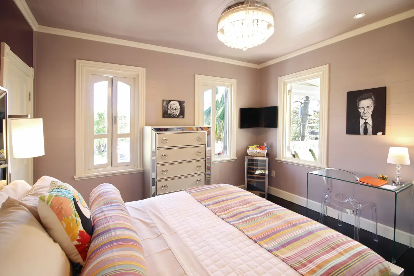 Basic Room Hill View Corner king bed with windows, desk and wall-mounted TV at The Fred.