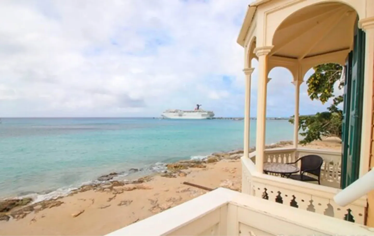 Honeymoon Room balcony with chairs overlooking the beach and sea at The Fred.