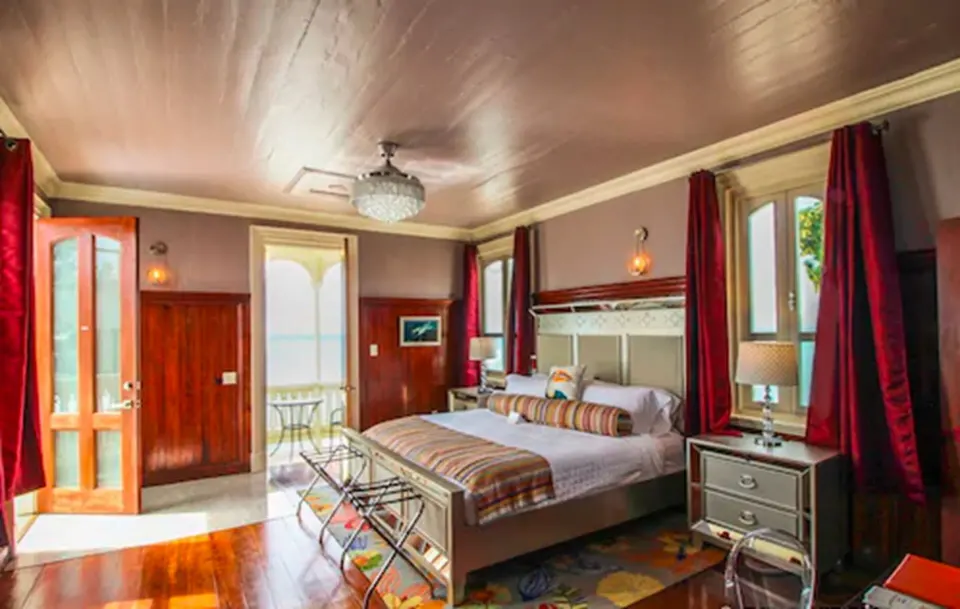 Honeymoon Room Rachel king bed and red curtains at The Fred.