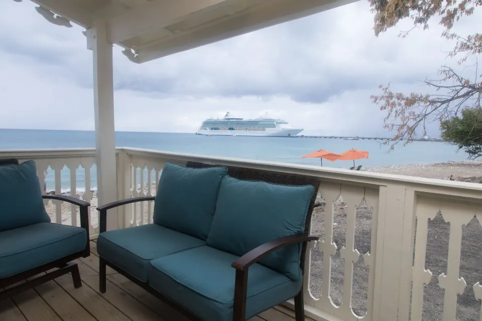 Honeymoon Suite terrace with cushioned seating and sea view at The Fred.