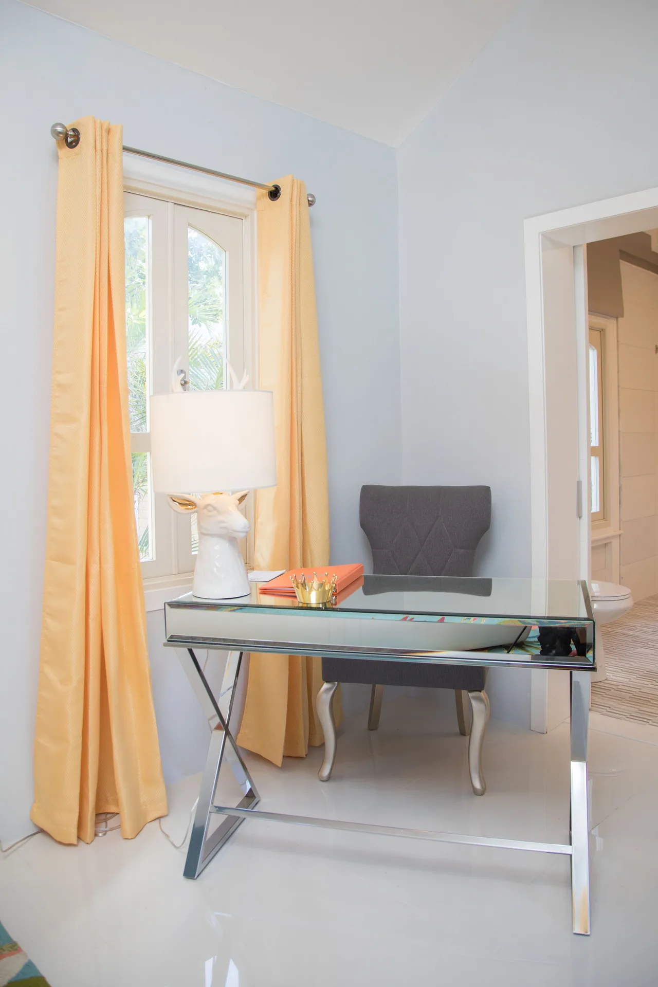 Glass desk and yellow curtains in the Panoramic Room at The Fred.