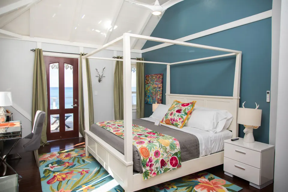 Premier Room Albert's Room at The Fred with four-poster bed, balcony doors, and sea view.
