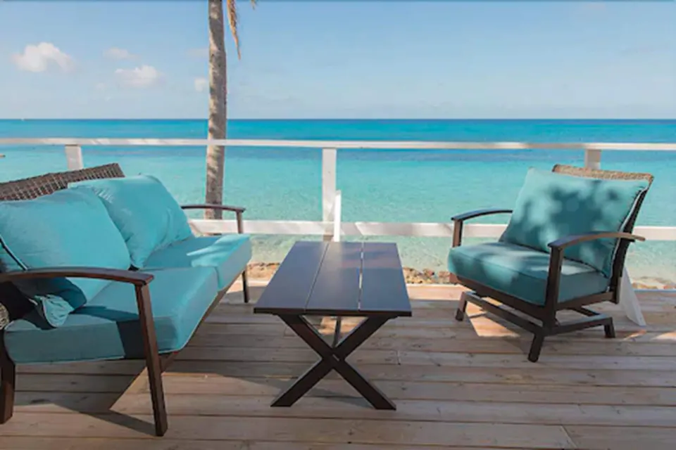 Premier Room Sea View at The Fred with balcony seating overlooking turquoise water.