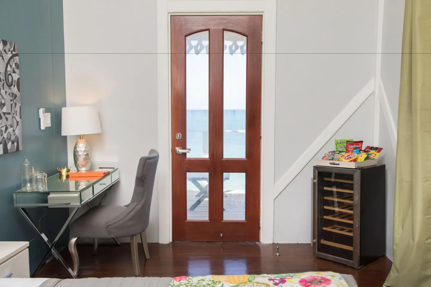 Premier Room Sea View at The Fred with a glass desk, wood door, ocean view, and small cooler.