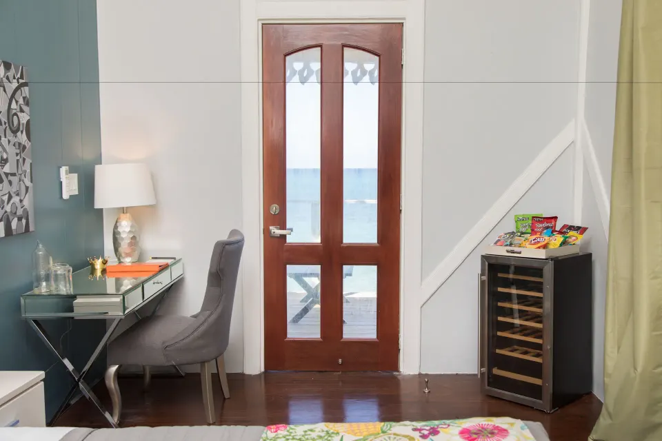 Premier Room Sea View at The Fred with a glass desk, wood door, ocean view, and small cooler.