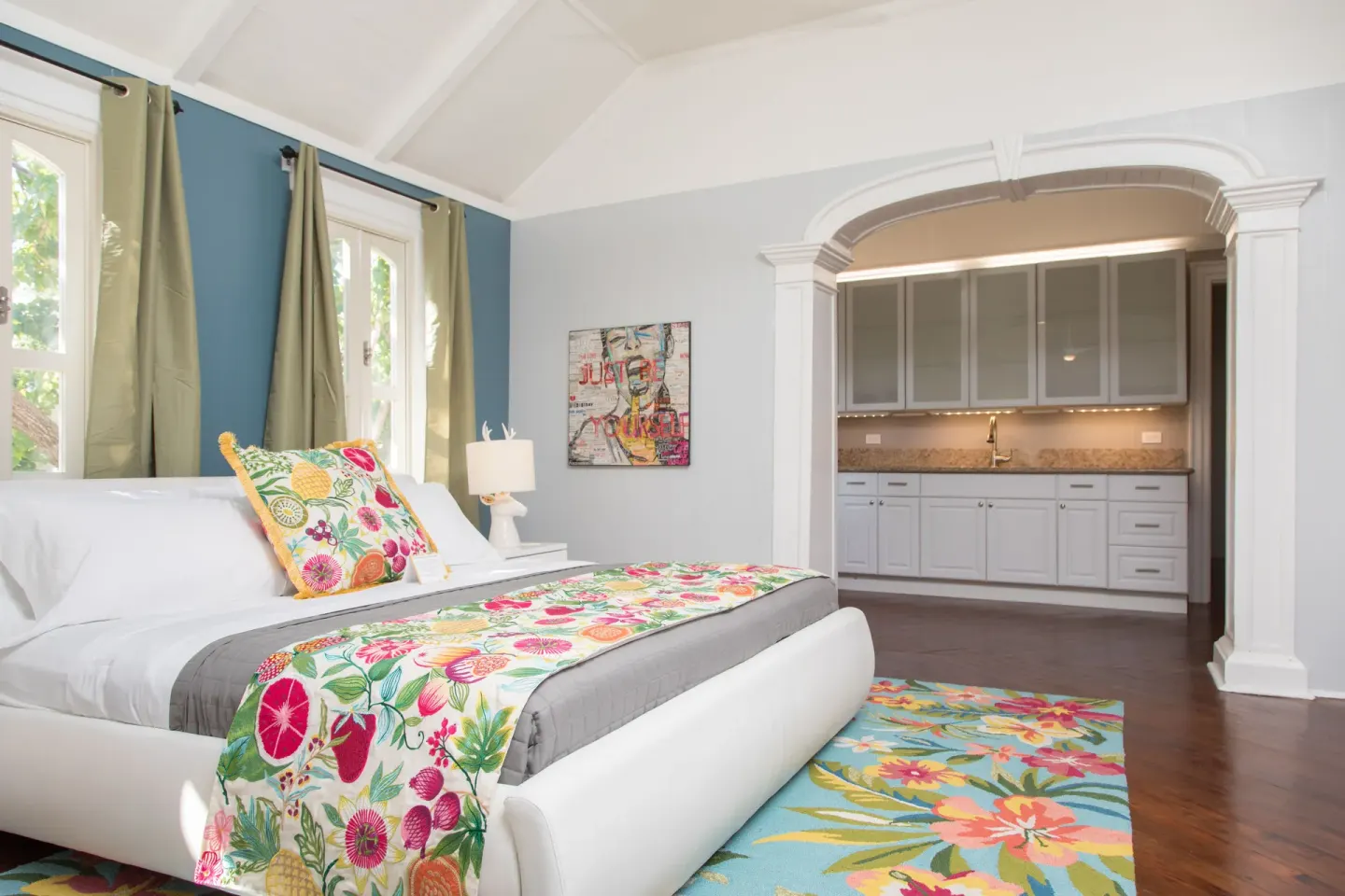 Premium multiple-bed room at The Fred with a white bed and kitchenette.