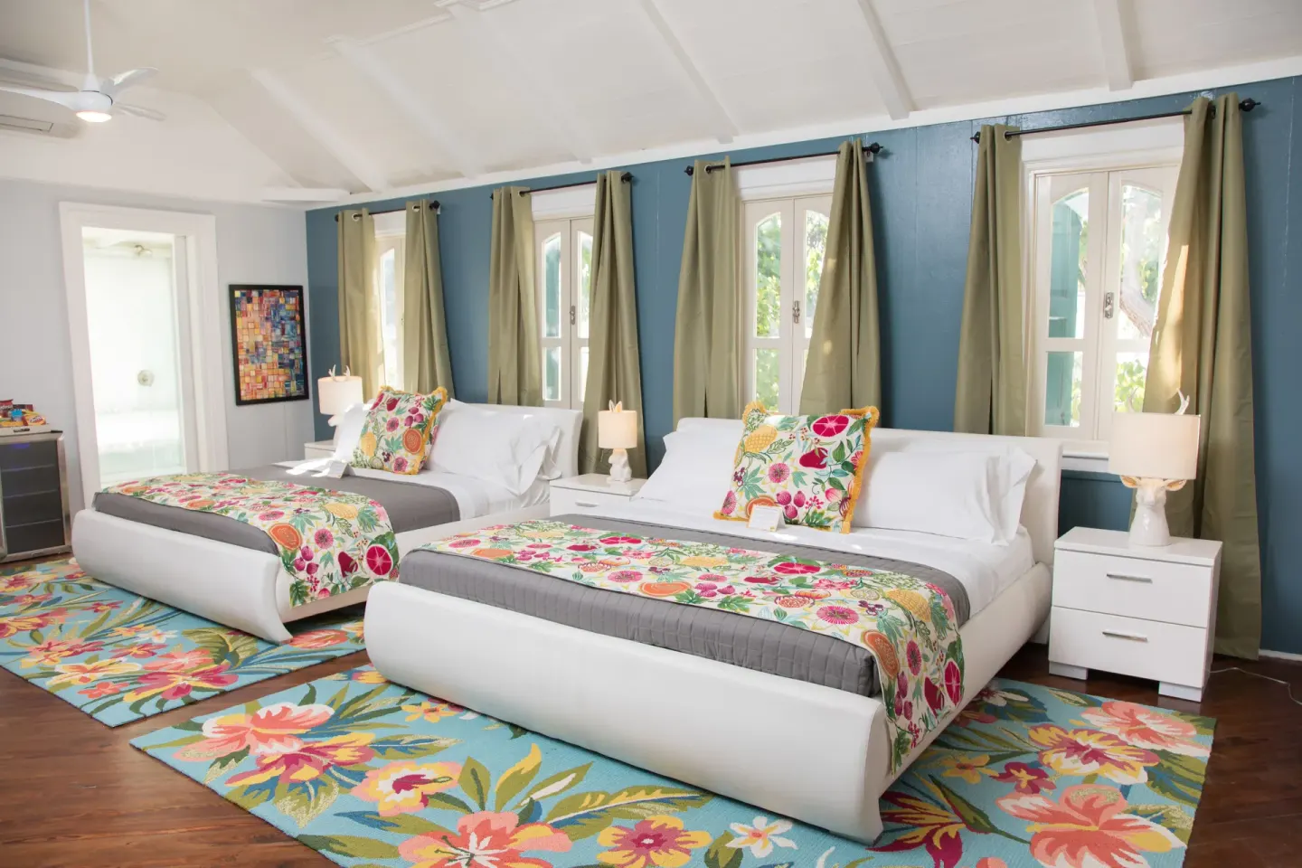 Two white beds with floral bedding in a Premium multiple-bed room at The Fred.