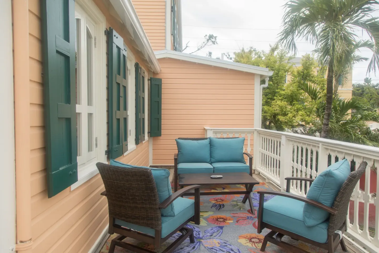 Premium studio suite balcony with blue cushioned seating at The Fred.
