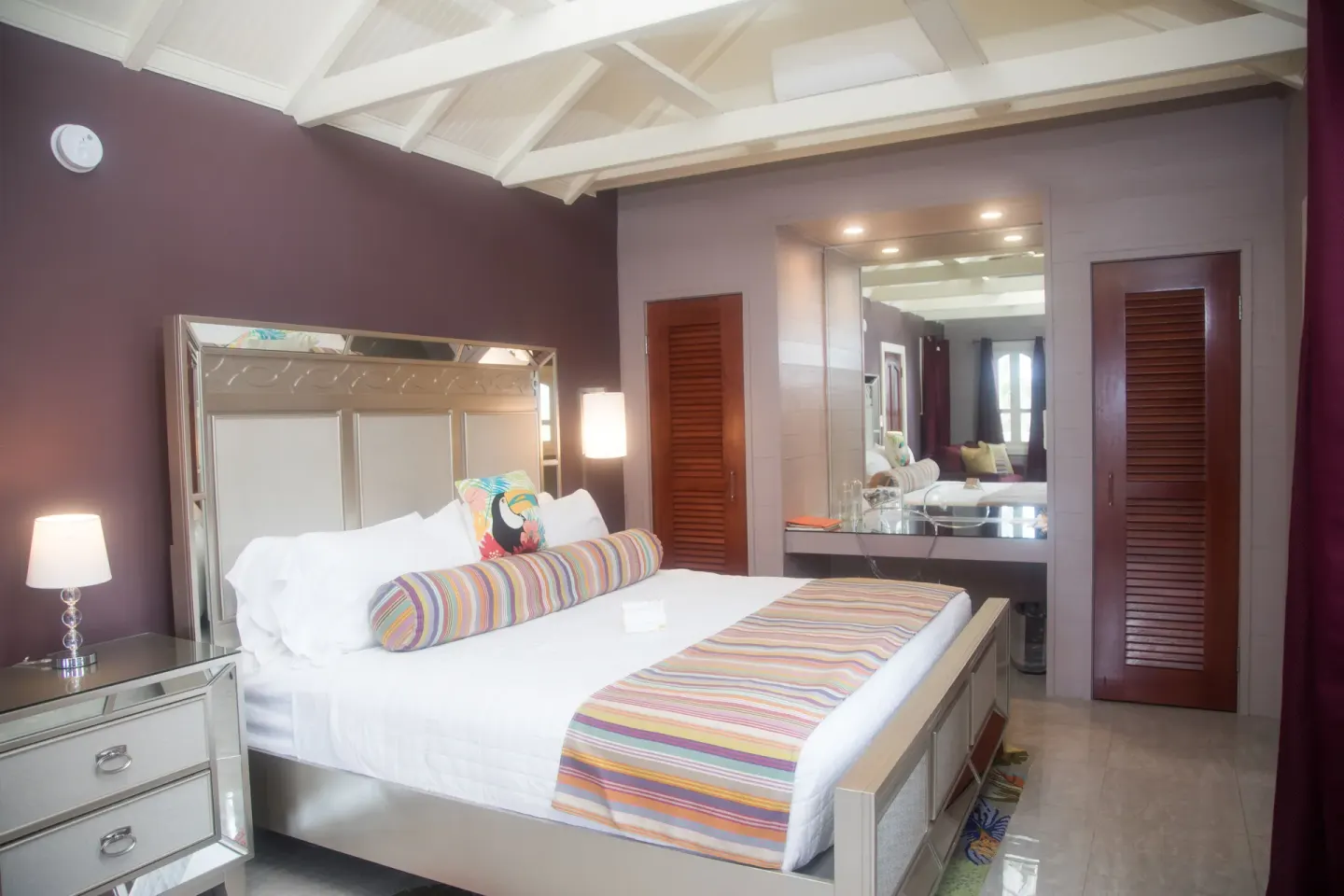 Premium studio suite king bed with mirrored headboard and vanity at The Fred.