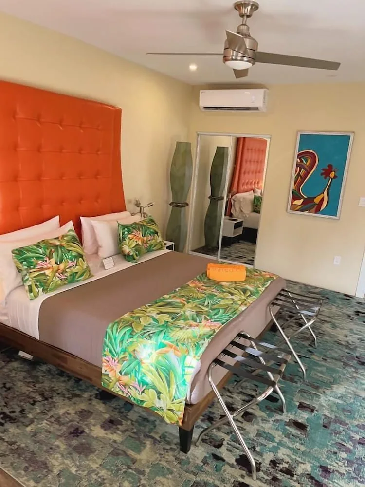 Standard Room Garden View king bed with tropical runner and mirrored closet at The Fred.