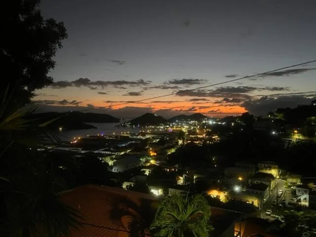Twilight harbor and town lights view near The Green Iguana Hotel.